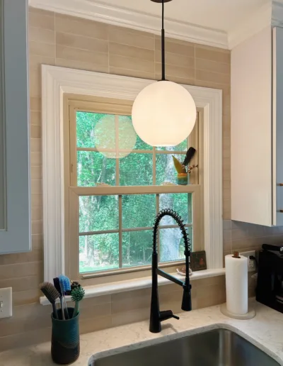 A kitchen with a sink and a window.