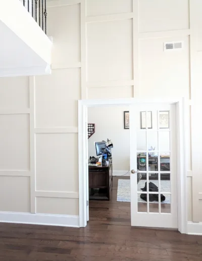 A living room with white walls and hardwood floors.