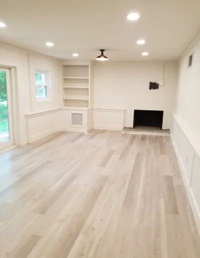 A living room with hardwood floors and a fireplace.