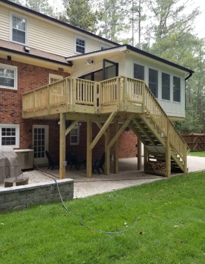 A house with a wooden deck and stairs.