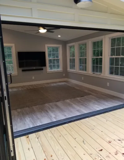 A sliding glass door in a home with a flat screen tv.