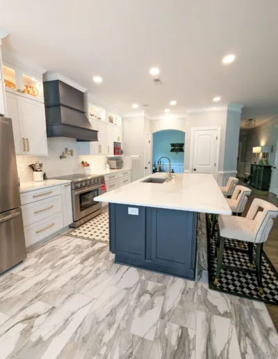 A kitchen with marble counter tops and stainless steel appliances.